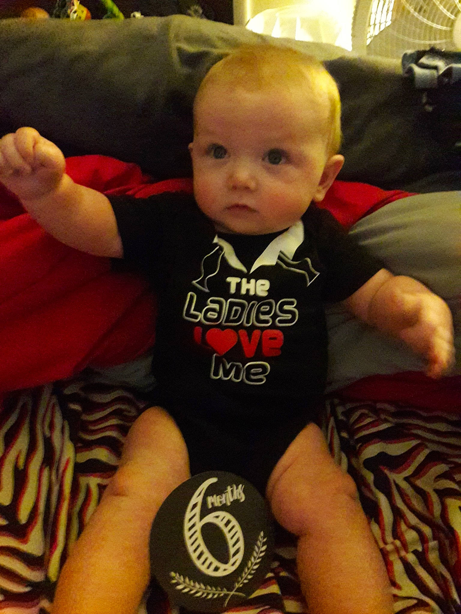 Jayden is registered to the contest to win money with this photo: arm, baby, cheek, child, cool, elbow, face, finger, hand, head, joint, leg, muscle, person, t_shirt, thigh, thumb, toddler