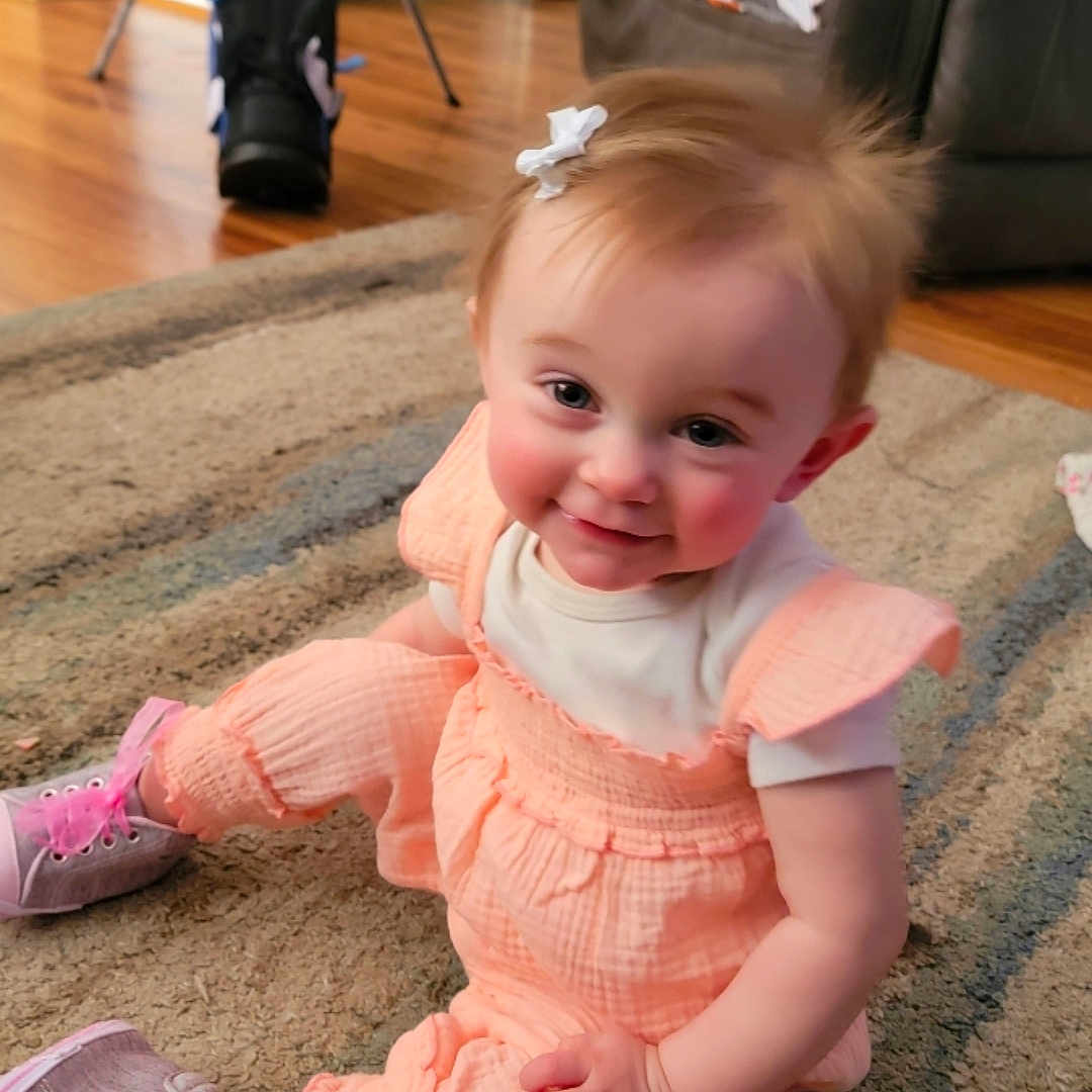 Paisleigh joined the competition — help win amazing prizes! architecture, baby, building, clothing, couch, dress, face, footwear, furniture, hardwood, head, indoors, pants, person, photography, portrait, shoe, sitting, sneaker, wood