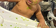 Jayton is registered to the contest to win money with this photo: baby, child, curly_hair, cute, expression, face, feeding, food, green_food, hand, high_chair, indoor, looking, messy, person, skin, surprised, table, toddler, wide_eyes