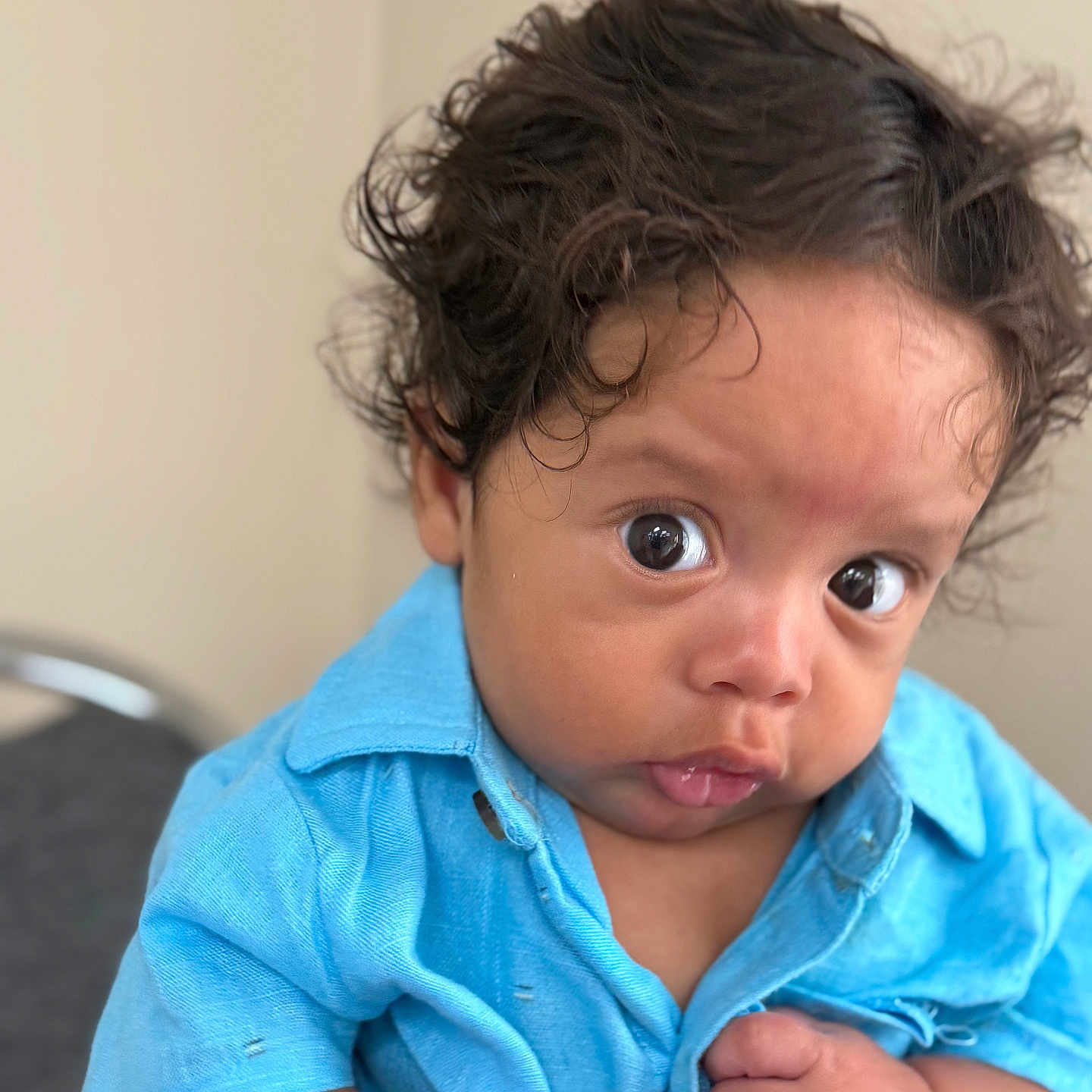 Jayton joined the competition — help win amazing prizes! baby, blue_shirt, button, child, closeup, clothing, curious, curly_hair, cute, expression, eyes, face, hands, human, indoor, infant, person, portrait, skin, young