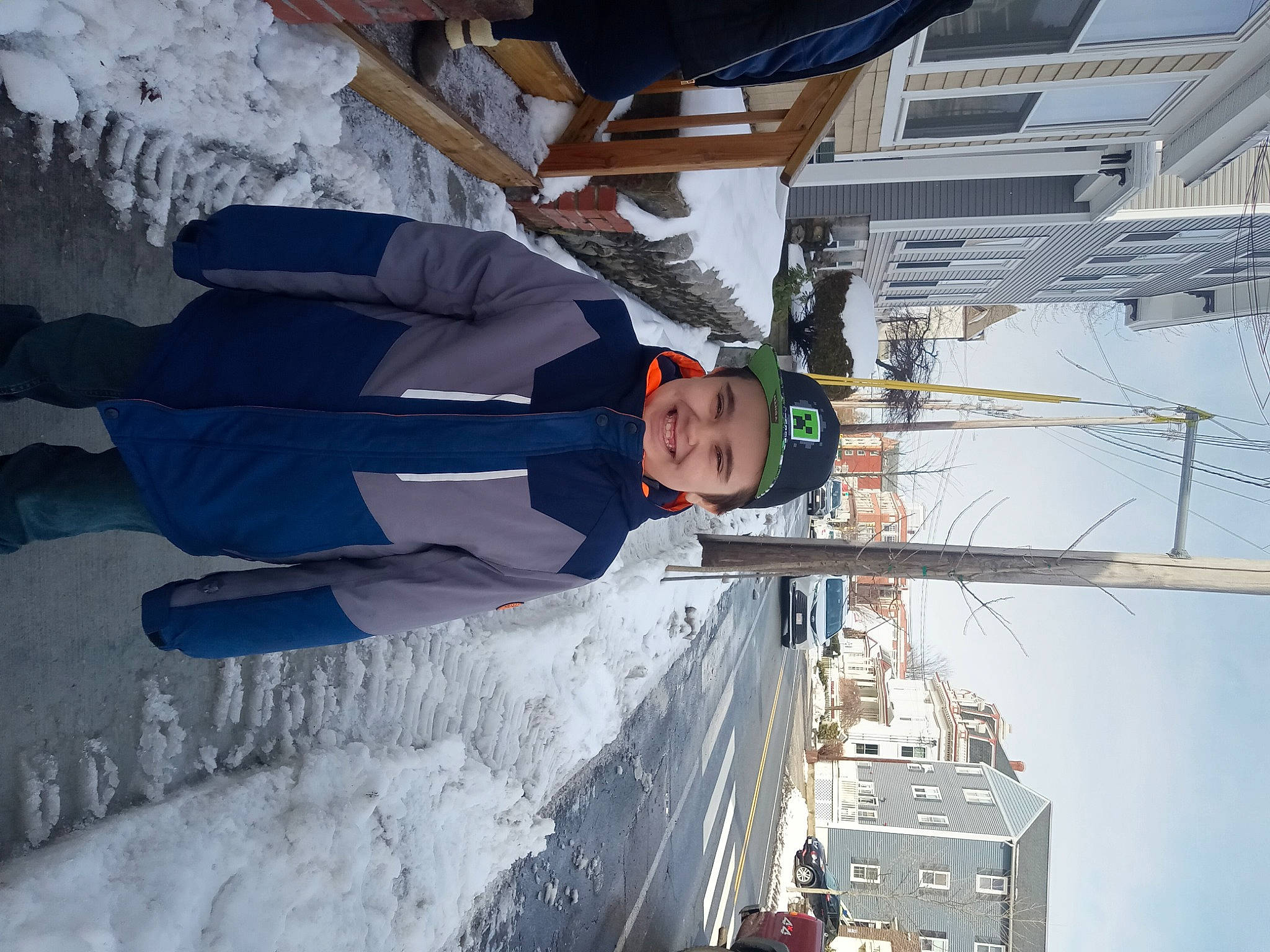 Wiley is registered to the contest to win money with this photo: boat, electric_blue, engineering, freezing, fun, glacial_landform, hat, headwear, ice_cap, joy, naval_architecture, person, recreation, ship, sky, slope, smile, snow, vehicle, water