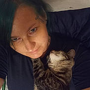 Green Bean joined the competition — help win amazing prizes! person, cat, tabby_cat, indoor, cuddle, hair, blue_hair, tattoo, face, pet, lying_down, black_shirt, closeup, affection, animal, comfort, relaxation, home, friendship, sleepy_cat