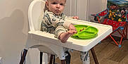 Myles joined the competition — help win amazing prizes! toddler, child, high_chair, pajamas, plate, food, tongue_out, indoor, room, door, wall, floor, rug, space_theme, chair, mickey_mouse, toy_chair, foot, baby, home