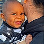 Jayden participe au concours pour gagner de l'argent avec cette photo : baby, smiling, child, person, adult, back_view, hugging, outdoor, daylight, cheerful, happy, clothing, earring, skin, head, face, hand, portrait, holding, family