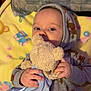 Atlas is registered to the contest to win money with this photo: baby, child, hoodie, reindeer_pattern, teddy_bear, blanket, soft_toy, cute, infant, sleepwear, hand, face, blue_blanket, yellow_blanket, indoors, cozy, lying_down, portrait, childhood, comfort