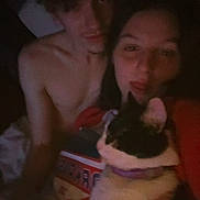 Pumpkin is registered to the contest to win money with this photo: animal, bed, calico_cat, casual, cat, cozy, dim_light, face, feline, human, indoor, person, pet, playful, portrait, relaxed, selfie, shirtless, together, young_adult