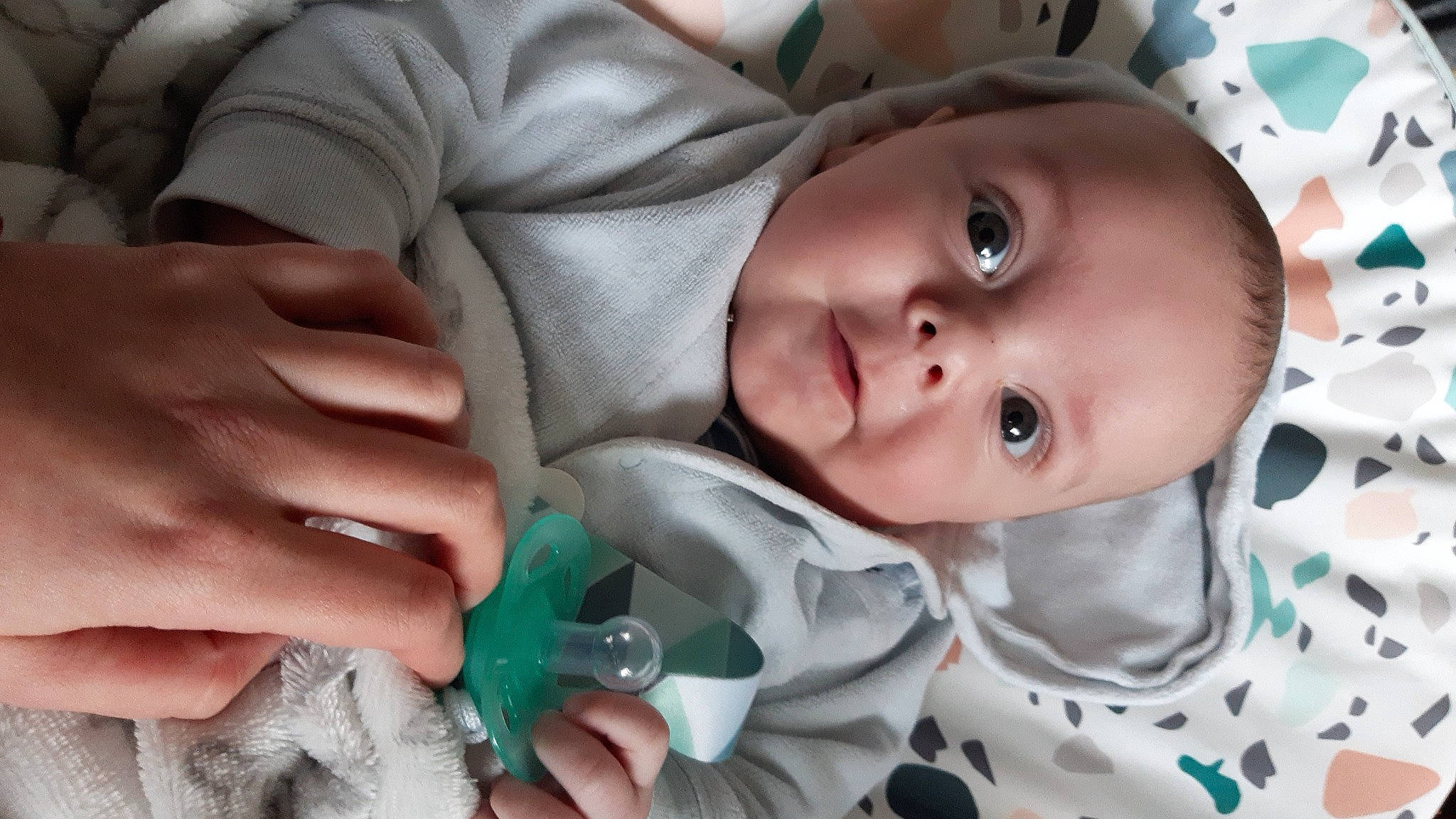 Harry is registered to the contest to win money with this photo: baby, baby_toddler_clothing, cheek, eye, eyebrow, face, finger, gesture, hand, happy, head, iris, lip, mammal, mouth, nose, person, skin, sleeve, smile