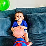 Maher joined the competition — help win amazing prizes! baby, child, infant, sitting, couch, sofa, balloon, pink_balloon, green_balloon, superhero_costume, blue_shirt, red_clothing, toy, playtime, indoor, living_room, portrait, smiling, face_paint, happy