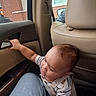Benjamin joined the competition — help win amazing prizes! toddler, child, baby, car, car_interior, door, door_handle, seated, reaching, curious, exploring, striped_shirt, overalls, adult, legs, vehicle, window, brick_building, daylight, portrait