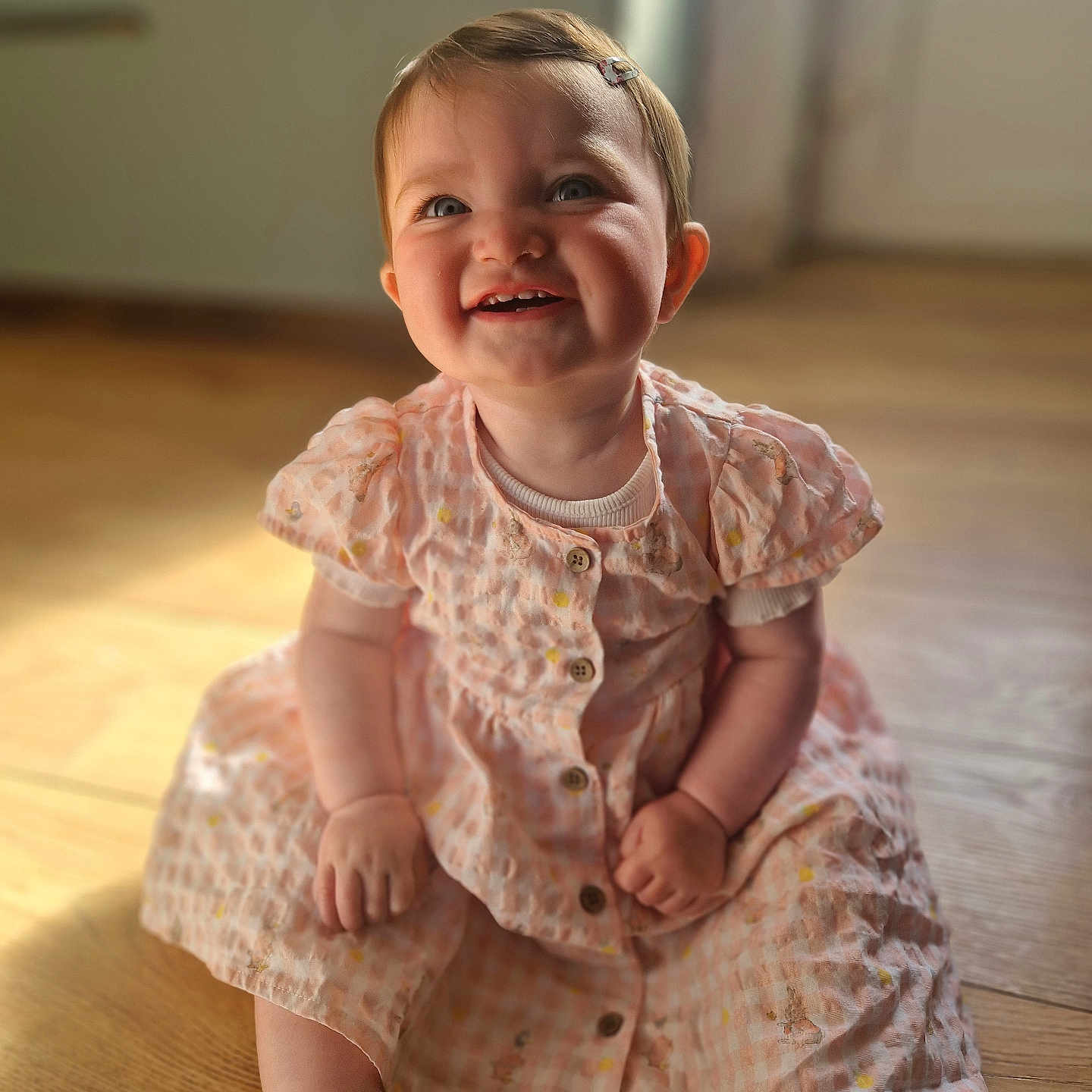 Lyra joined the competition — help win amazing prizes! baby, babylaughing, bodypart, clothing, dress, face, finger, hand, happy, hardwood, head, hosiery, laughing, person, photography, portrait, sitting, smile, sock, wood