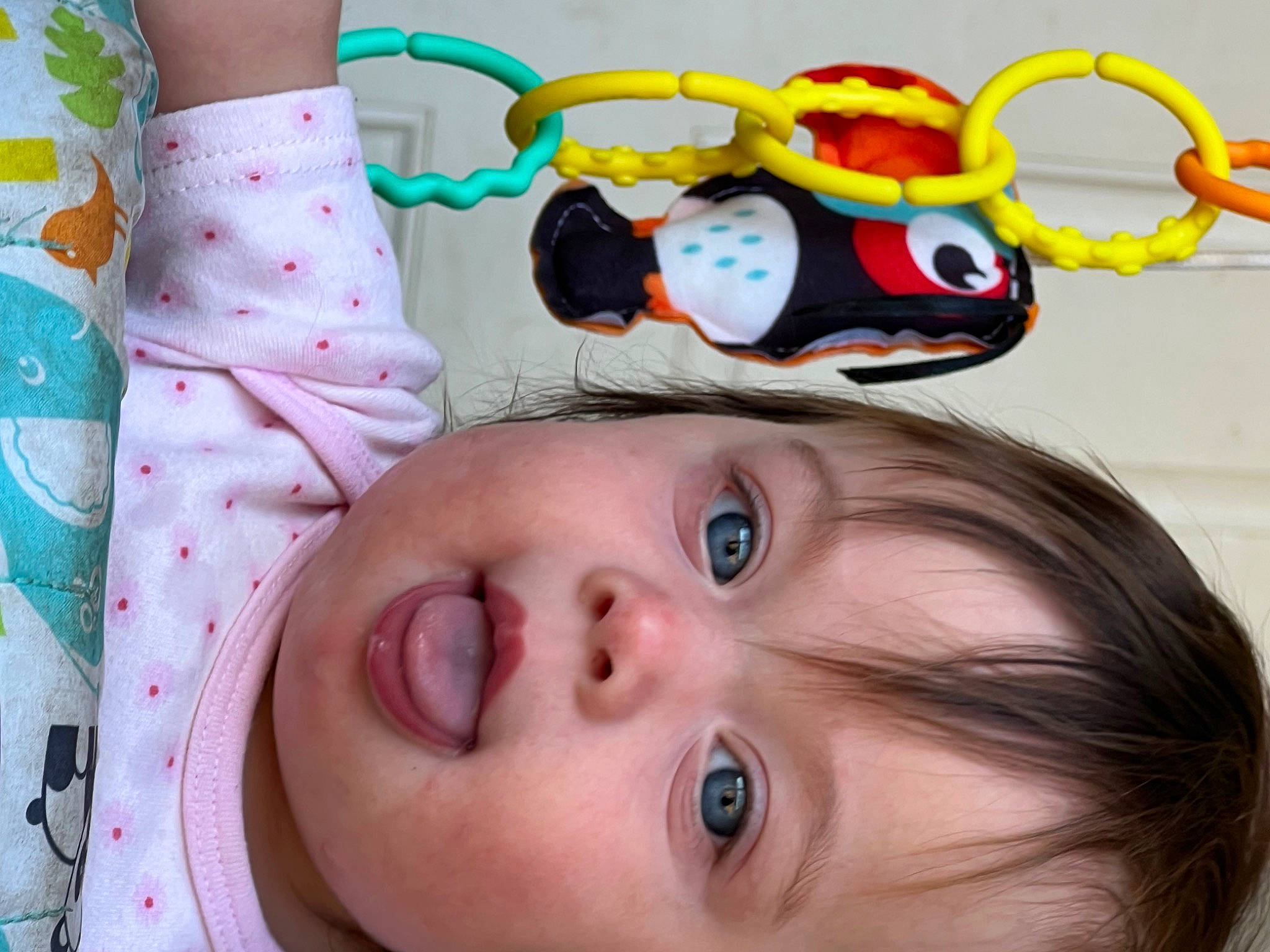 Scarlett is registered to the contest to win money with this photo: baby, baby_products, baby_toddler_clothing, cheek, child, eyelash, facial_expression, fun, happy, head, iris, linens, mouth, nose, pattern, person, pink, skin, toddler, white