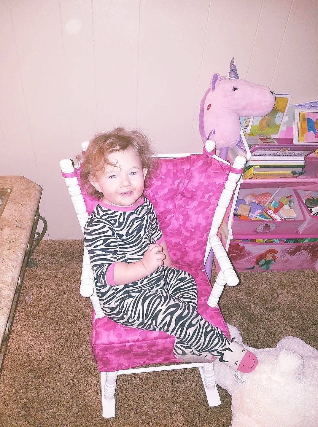 Lillyonna is registered to the contest to win money with this photo: baby_toddler_clothing, chair, child, fun, human_leg, joy, knee, magenta, pattern, person, pink, purple, room, sitting, sock, toddler, toy, working_animal