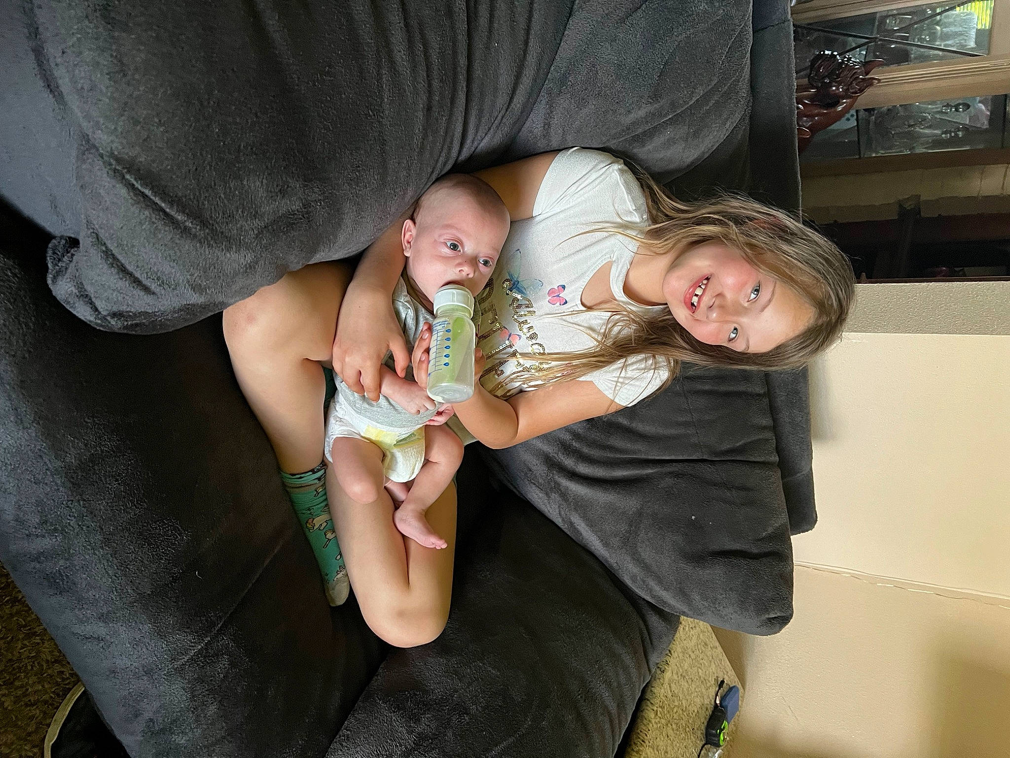 Lillyonna joined the competition — help win amazing prizes! baby, baby_products, chair, child, comfort, couch, finger, fun, gesture, hand, happy, human_leg, joy, lap, leg, nail, person, room, sitting, thigh