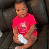Alora is registered to the contest to win money with this photo: baby, child, sitting, red_clothing, minnie_mouse, bow, white_bow, shoes, sparkly_shoes, leather_couch, furniture, indoor, portrait, cute, adorable, person, smiling, young_child, earrings, curly_hair