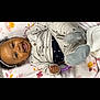 Dahlia is registered to the contest to win money with this photo: baby, bodypart, bonnet, clothing, coat, face, glove, happy, hat, head, hood, jacket, laughing, mouth, newborn, person, photography, portrait, smile, teeth