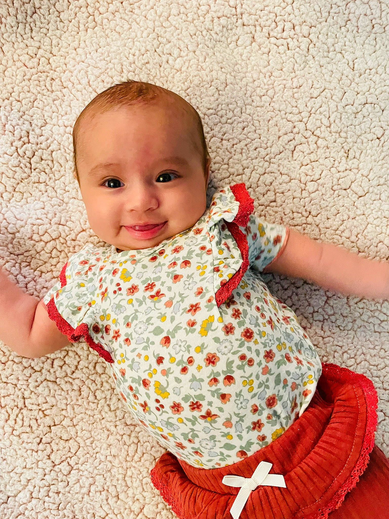 Lilianna is registered to the contest to win money with this photo: baby_toddler_clothing, cheek, chin, dress, facial_expression, finger, floor, flooring, hairstyle, happy, human_body, joint, joy, leg, neck, outerwear, person, skin, sleeve, smile
