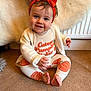 baby, child, smile, headband, orange, pumpkin, carpet, sitting, hand, clothing, cute, indoor, radiator, white_cardigan, feet, portrait, happy, face, infant, cozy