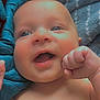 Zaiden is registered to the contest to win money with this photo: baby, infant, smile, face, eyes, hand, fist, skin, blanket, blue, texture, happy, cute, child, newborn, expression, lying_down, closeup, portrait, indoors