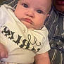 Lauren joined the competition — help win amazing prizes! baby, infant, person, child, face, clothing, shirt, pants, floral_pattern, striped_shirt, couch, indoor, portrait, closeup, skin, hand, expression, pout, eyes, holding
