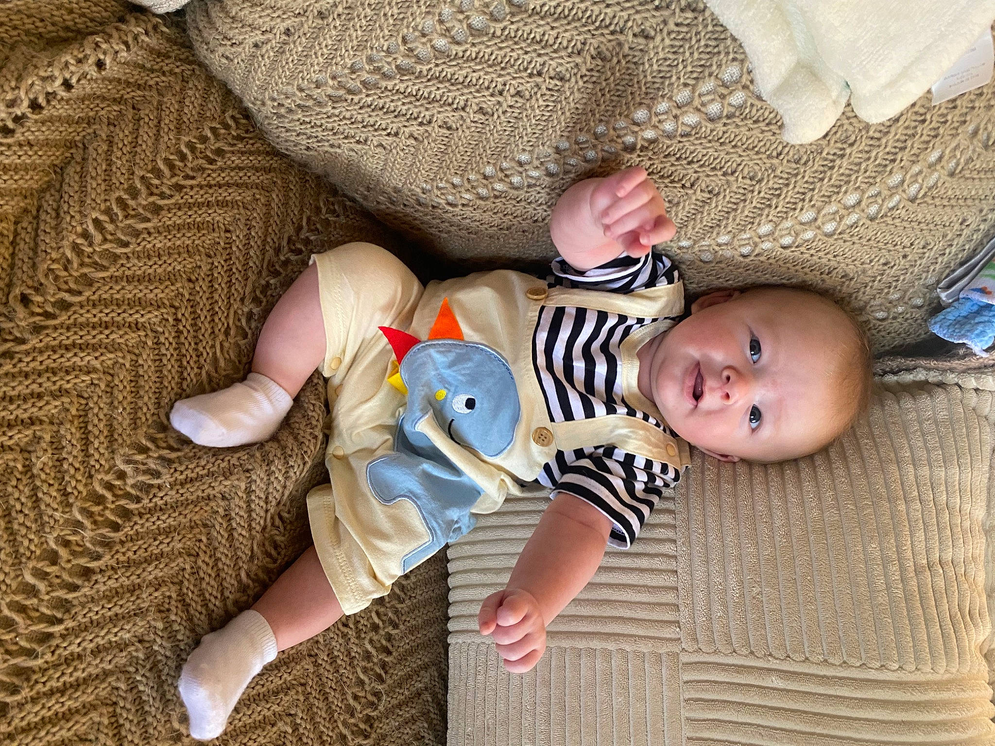 Declan joined the competition — help win amazing prizes! baby, baby_products, baby_sleeping, baby_toddler_clothing, cheek, child, comfort, finger, foot, linens, nail, pattern, person, room, sitting, skin, sock, textile, toddler, toy