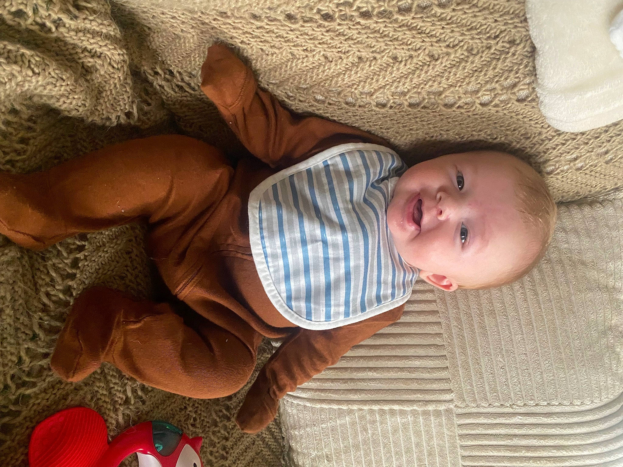 Declan is registered to the contest to win money with this photo: arm, baby, baby_products, baby_toddler_clothing, cheek, child, comfort, eye, facial_expression, hand, head, human_body, iris, linens, nose, person, skin, sleeve, toddler, tree