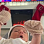 Jacob joined the competition — help win amazing prizes! baby, mittens, white_hat, fireplace, stockings, holiday, cozy, infant, clothing, indoor, blanket, warmth, celebration, comfort, person, cute, face, relaxation, festive, home