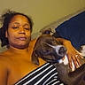 Yogi joined the competition — help win amazing prizes! woman, dog, couch, striped_blanket, indoor, relaxed, pet, comfort, casual, portrait, brown_dog, human, friendship, home, resting, furniture, love, striped_clothing, hand, cozy