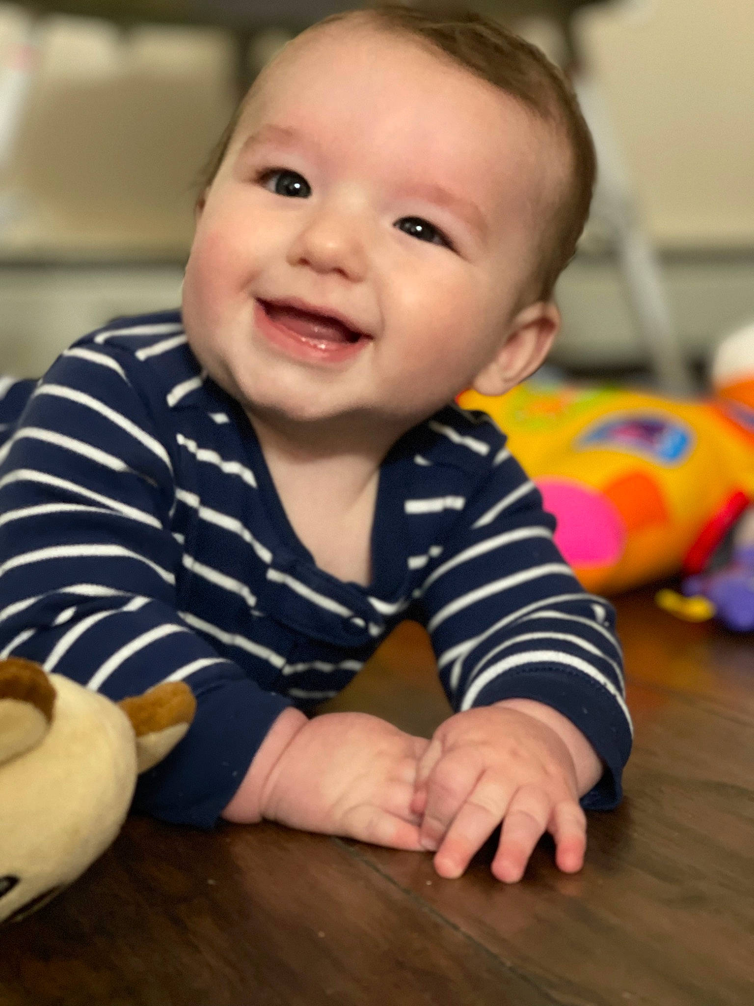 Colton is registered to the contest to win money with this photo: baby, baby_crawling, baby_playing_with_toys, baby_toddler_clothing, cheek, finger, floor, flooring, fun, happy, iris, joy, nose, person, product, skin, sleeve, smile, standing, toddler