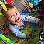 baby, child, smiling, playmat, toy, colorful, happy, infant, floor, cute, indoors, bright, clothing, person, playtime, cheerful, face, expression, hands, toddler
