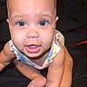 Aaliyah joined the competition — help win amazing prizes! baby, child, infant, crawling, blue_eyes, face, skin, arms, legs, toes, clothing, sleeveless, looking_up, curious, close_up, indoors, person, cute, young, expression