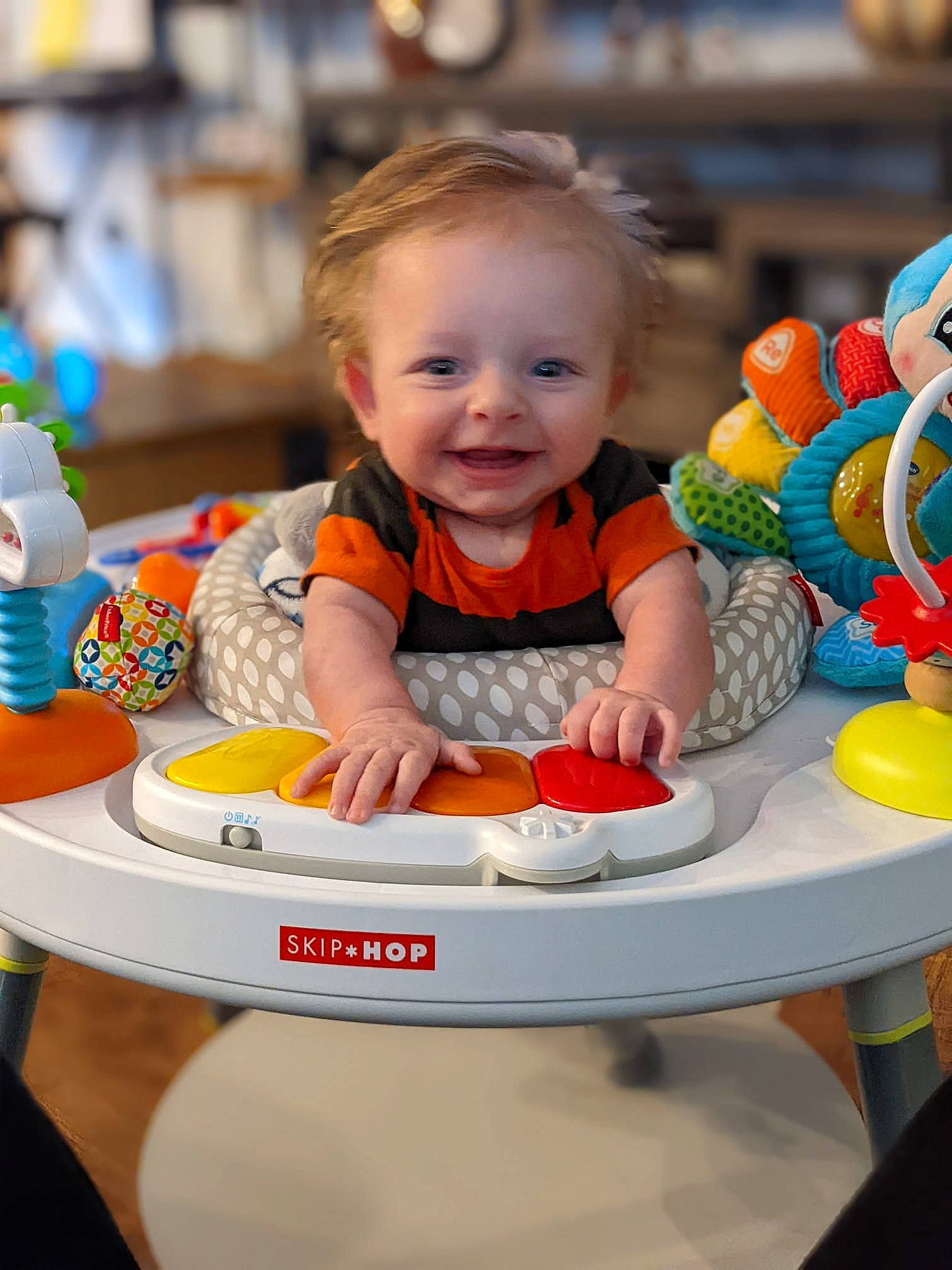 Jaiden is registered to the contest to win money with this photo: baby, baby_playing_with_toys, baby_toddler_clothing, child, event, eye, fun, happy, head, joy, leisure, orange, person, photograph, product, sharing, sitting, smile, snapshot, table