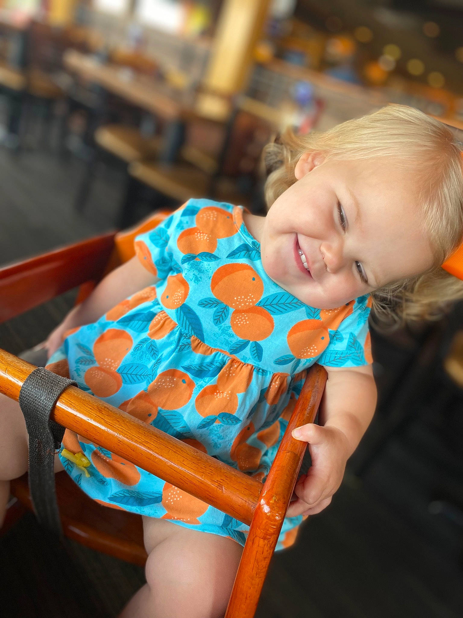 Brinkley is registered to the contest to win money with this photo: baby, baby_products, baby_toddler_clothing, chair, child, comfort, dress, electric_blue, event, fun, happy, human_leg, joy, leisure, pattern, person, room, sitting, smile, thigh