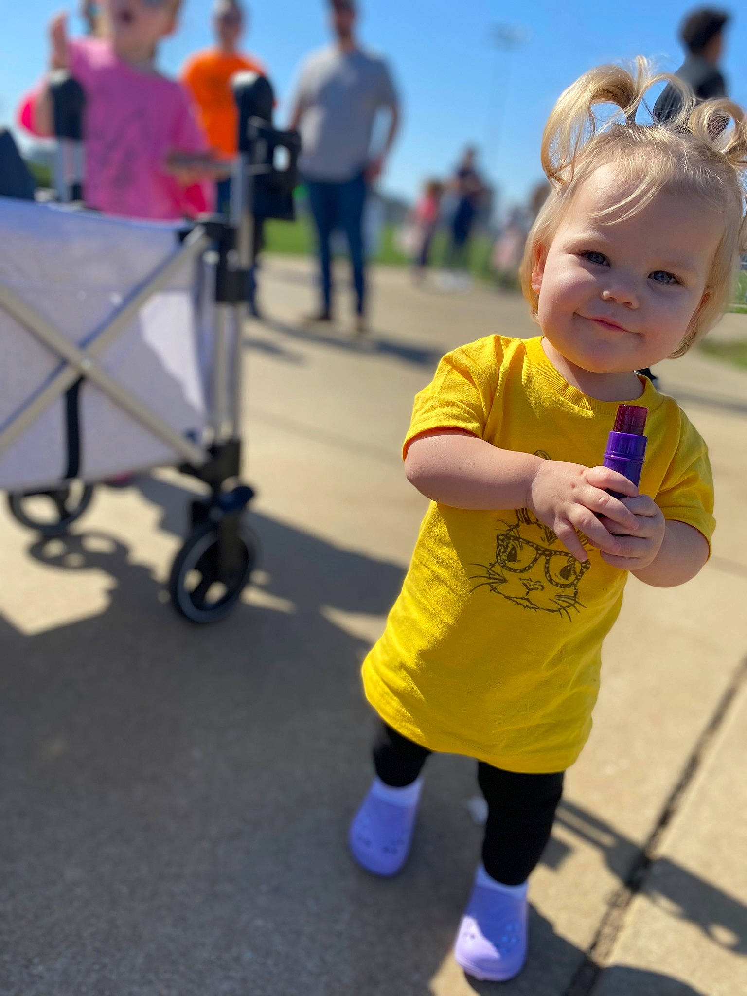 Brinkley is registered to the contest to win money with this photo: baby_toddler_clothing, clothing, electric_blue, event, footwear, fun, grass, happy, joy, leisure, person, recreation, sky, smile, sneakers, sock, t_shirt, tire, toddler, travel