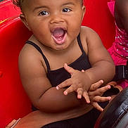 Ariel joined the competition — help win amazing prizes! toddler, child, smiling, clapping, curly_hair, black_outfit, red_toy_car, seatbelt, outdoor, grass, happy, person, driving_wheel, play, fun, cute, summer, sitting, joy, friend