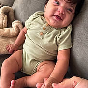 Saint joined the competition — help win amazing prizes! baby, infant, child, smiling, hand, couch, blanket, onesie, skin, face, fingers, foot, toe, soft, cute, indoor, person, portrait, seated, cozy