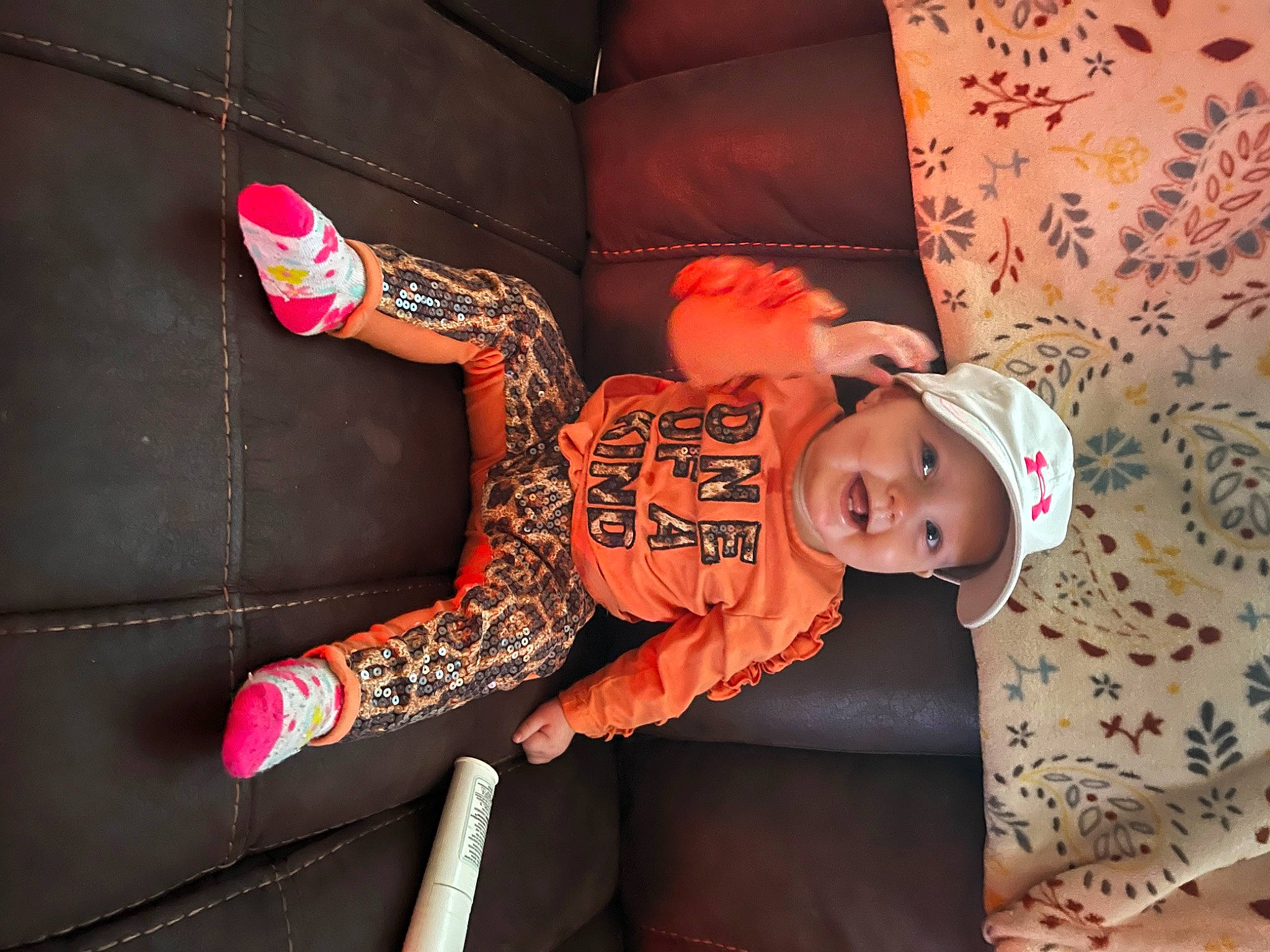Mazelynn joined the competition — help win amazing prizes! baby, baby_toddler_clothing, carmine, child, comfort, couch, elbow, flash_photography, fun, hat, headwear, human_body, joy, orange, pattern, person, pink, room, sitting, sleeve