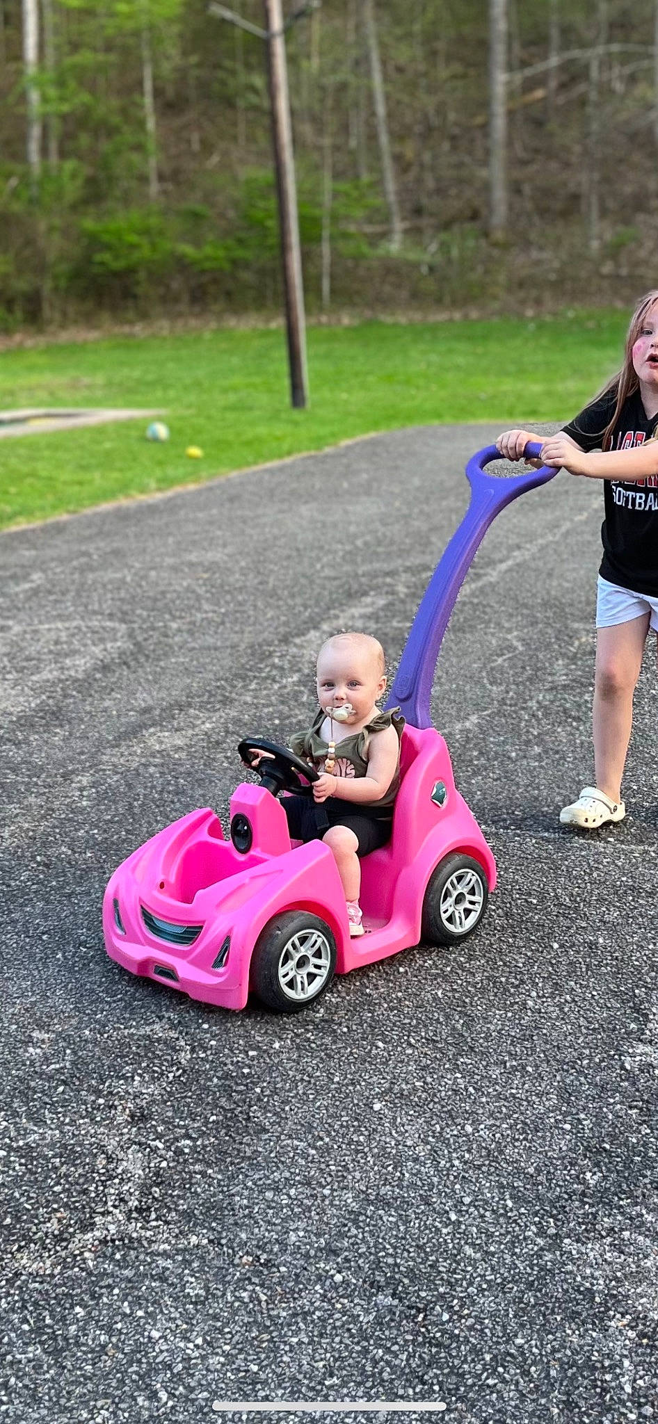 Mazelynn is registered to the contest to win money with this photo: automotive_design, automotive_tire, automotive_wheel_system, fun, grass, leisure, magenta, motor_vehicle, person, photograph, pink, plant, product, recreation, riding_toy, rolling, tire, toddler, toy, vehicle