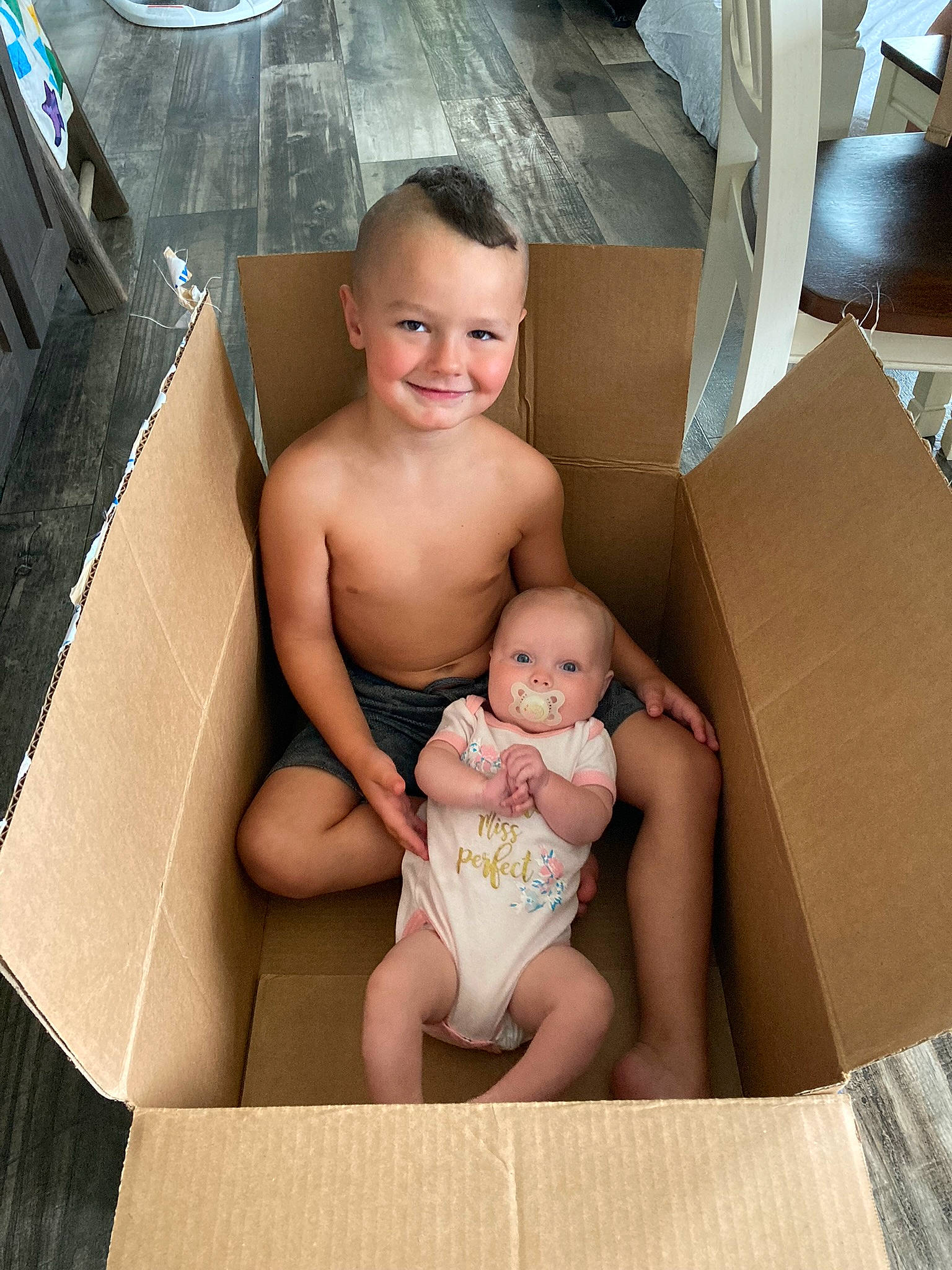 Daxton joined the competition — help win amazing prizes! abdomen, arm, baby, barefoot, carton, chest, comfort, foot, happy, human, human_body, joy, knee, mammal, person, shipping_box, smile, stomach, thigh, toddler