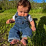 Axel is registered to the contest to win money with this photo: baby, barefoot, casual_clothing, child, clouds, curious, daytime, denim_overalls, grass, greenery, nature, outdoor, person, portrait, sitting, sky, summer, sunlight, toddler, young_child