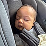 baby, infant, sleeping, car_seat, graco, child, seatbelt, blanket, striped_clothing, closeup, face, head, resting, safety, child_safety_seat, young_child, indoors, comfort, soft_texture, peaceful