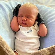 Clayton is registered to the contest to win money with this photo: baby, newborn, sleeping, mittens, blanket, cushion, infant, cozy, comfort, soft, white_onesie, peaceful, cute, resting, indoor, portrait, human, child, closeup, relaxation