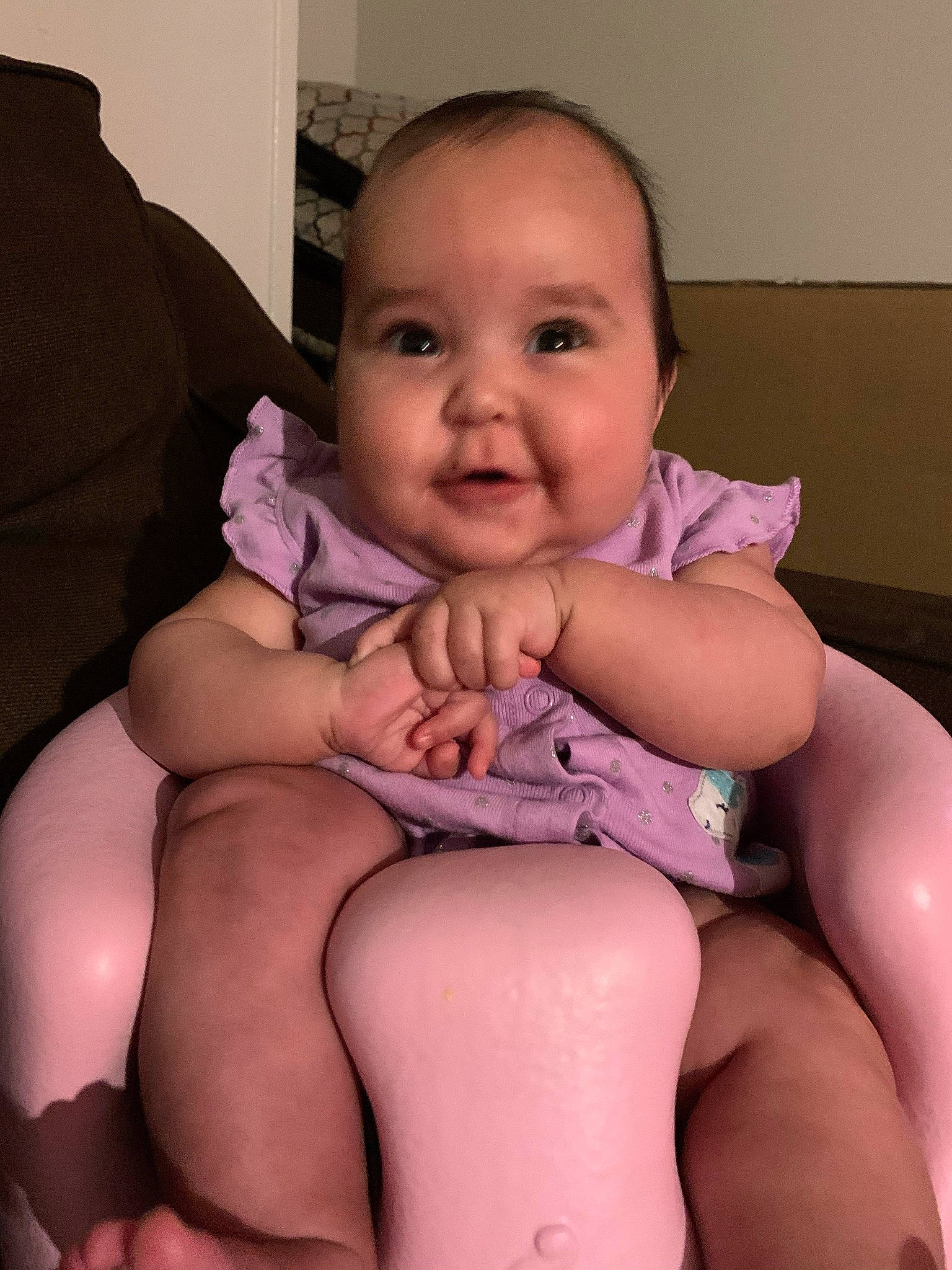 Jaylani is registered to the contest to win money with this photo: arm, baby_toddler_clothing, cheek, comfort, face, hand, human_body, joint, knee, leg, lip, mouth, muscle, neck, person, purple, shoulder, skin, smile, stomach
