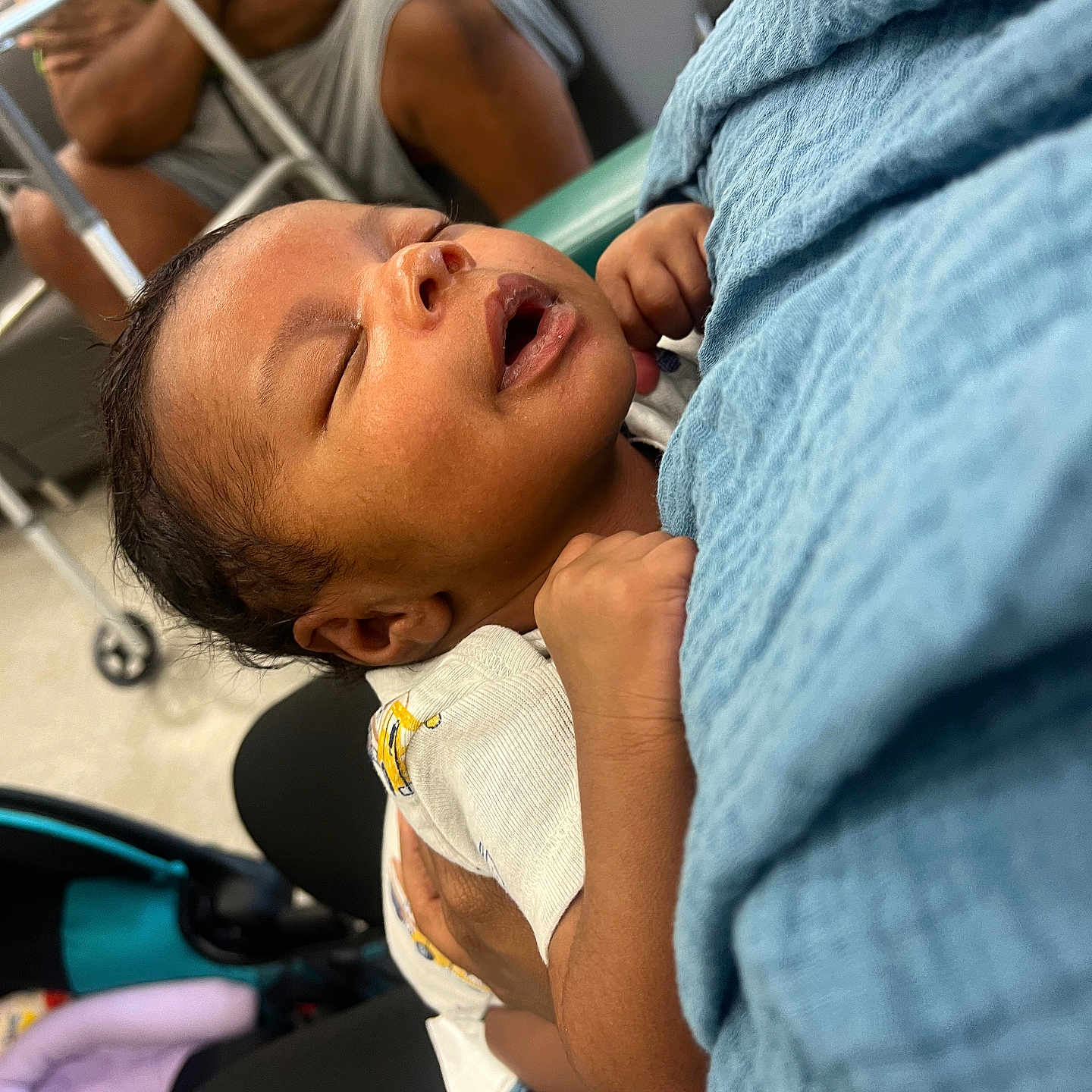 Asiah is registered to the contest to win money with this photo: adult, arms, baby, blanket, care, closeup, clothing, comfort, face, hand, holding, indoor, peaceful, person, rest, seated, sleeping, soft, stroller, toddler