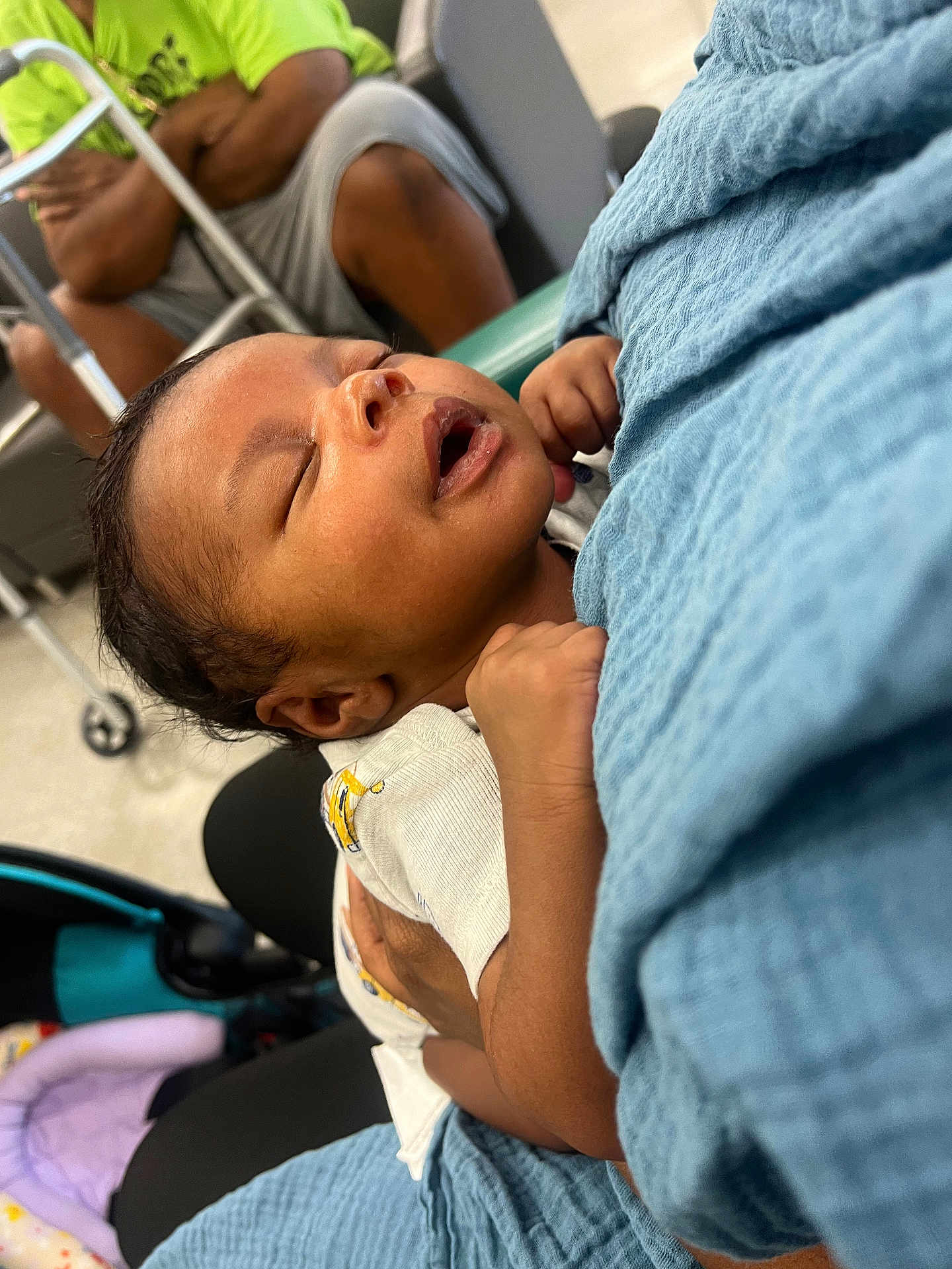 Asiah is registered to the contest to win money with this photo: baby, sleeping, blanket, arms, person, clothing, indoor, stroller, seated, adult, hand, comfort, rest, toddler, care, closeup, face, holding, soft, peaceful