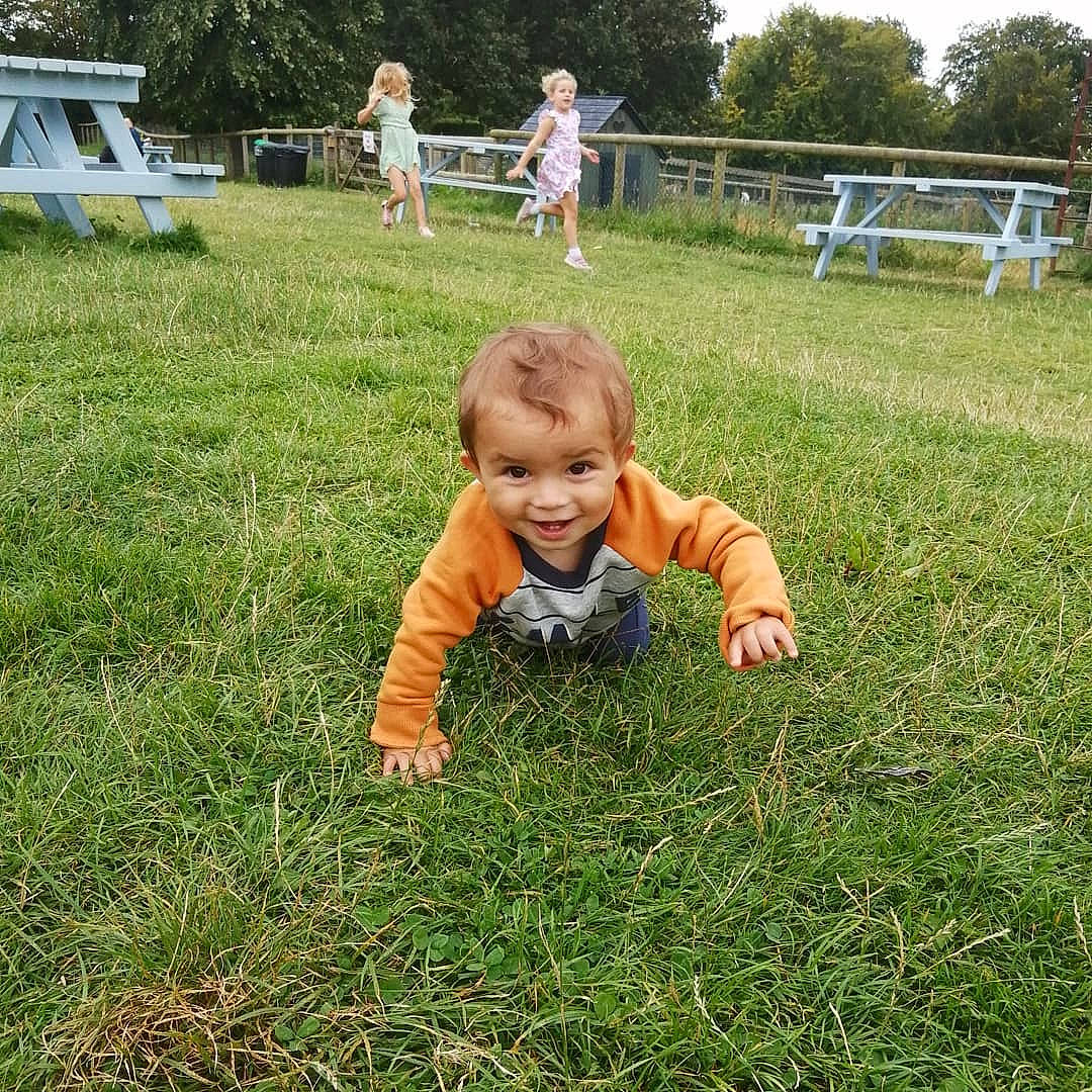 Loki is registered to the contest to win money with this photo: baby, baby_toddler_clothing, blurred, fun, garden, grass, grass_family, grassland, groundcover, happy, landscape, lawn, meadow, people_in_nature, person, plant, sitting, smile, soil, summer