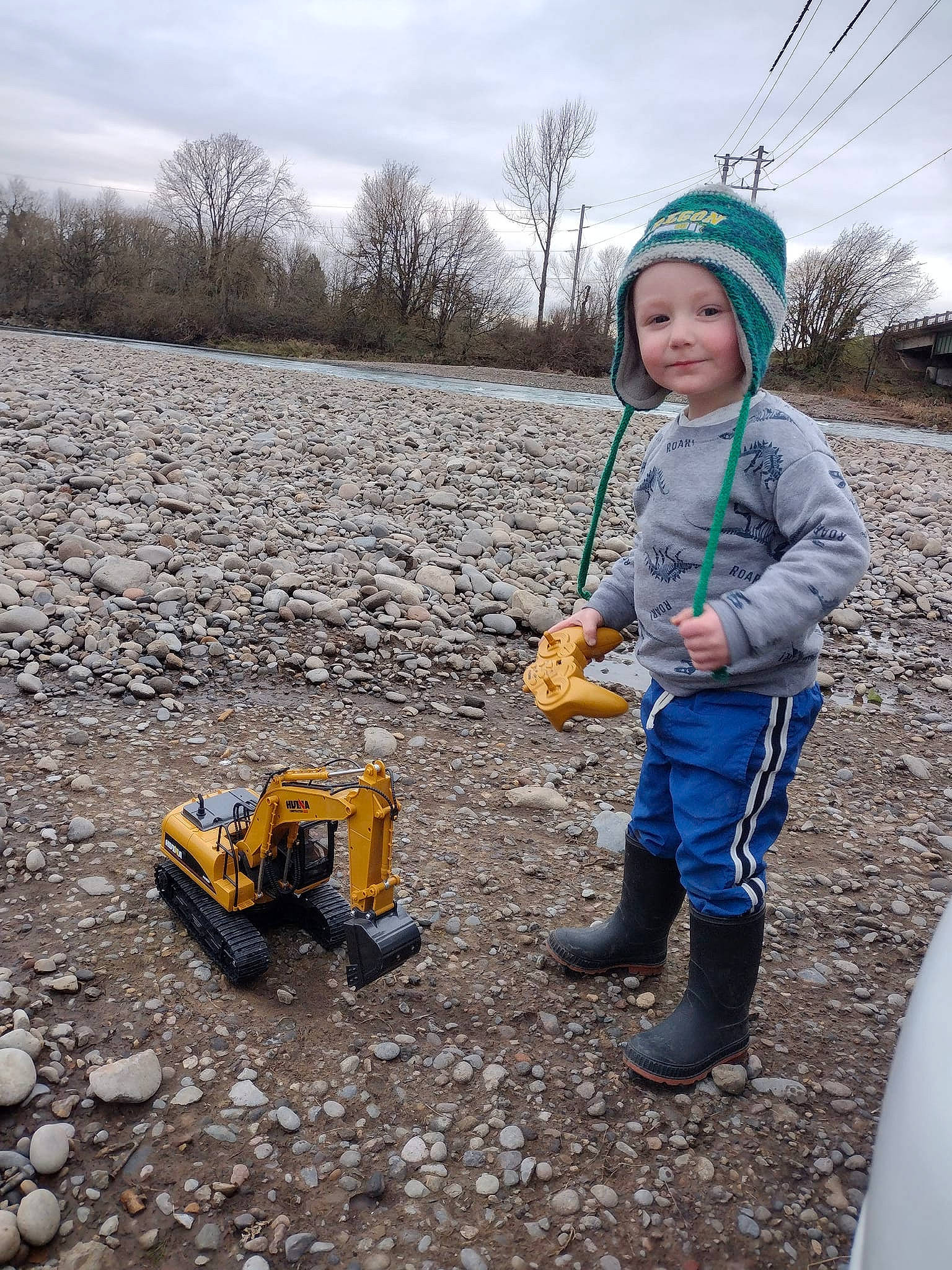 Ryder James is registered to the contest to win money with this photo: asphalt, cloud, construction_equipment, fun, grass, headwear, joy, landscape, machine, people_in_nature, person, plant, recreation, road_surface, sky, soil, tire, toddler, toy, tree