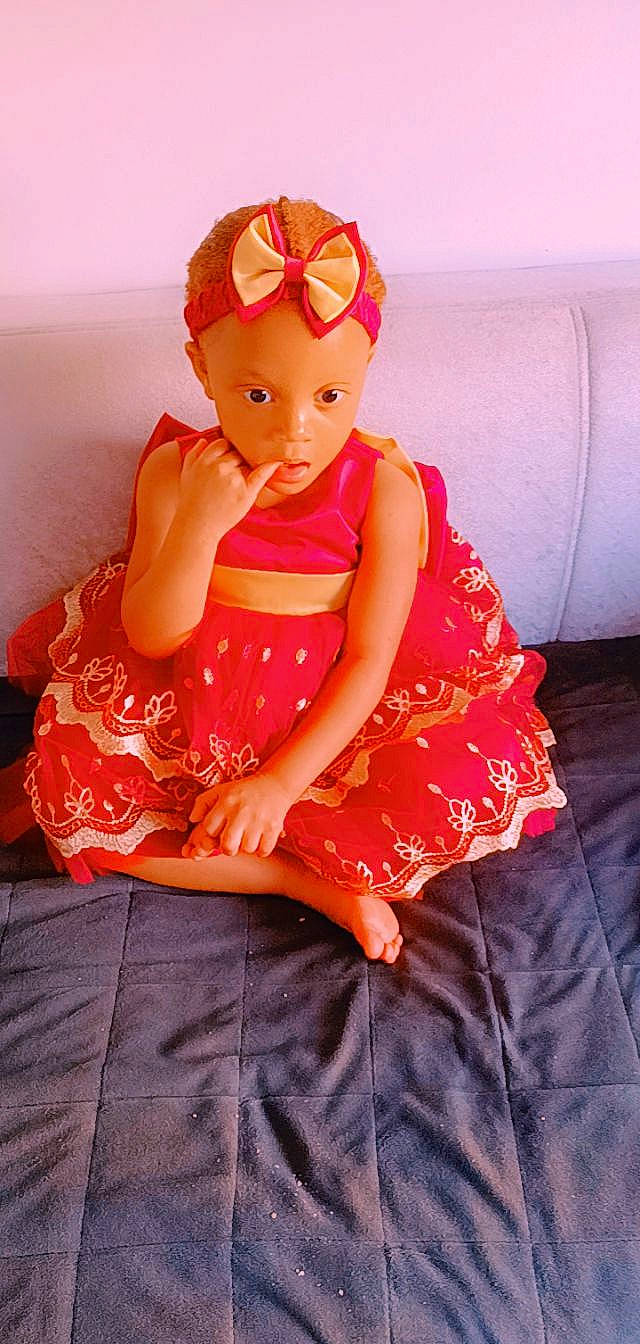 Kadija a rejoint le concours — aidez-le/la à gagner de superbes lots ! baby_toddler_clothing, comfort, day_dress, doll, dress, eye, face, fashion_design, hand, head, human_body, lip, neck, one_piece_garment, orange, person, pink, red, sleeve, thigh