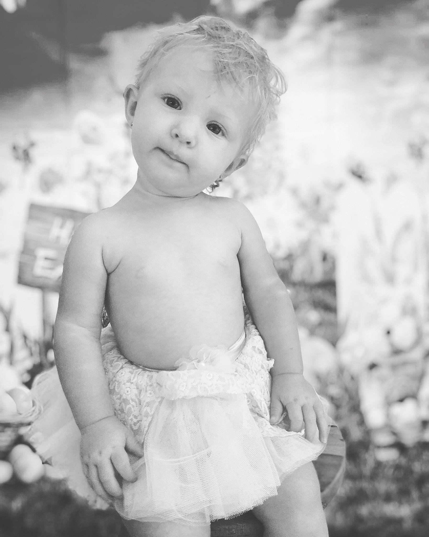 Amelia is registered to the contest to win money with this photo: black_and_white, eye, face, facial_expression, flash_photography, gesture, hair, happy, head, human_body, iris, monochrome, people_in_nature, person, photograph, plant, skin, smile, style, toddler