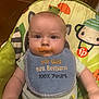 Bryson is registered to the contest to win money with this photo: baby, bib, food_stain, baby_seat, cartoon, animal_print, infant, face, mouth, clothing, cute, child, messy, seat, indoor, expression, person, smudge, colorful, young