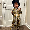 Kaison is registered to the contest to win money with this photo: child, boy, cowboy_hat, camo_outfit, boots, door, floor, wood_floor, wall, smile, tongue_out, standing, indoor, playful, fashion, clothing, person, hat, happy, pose